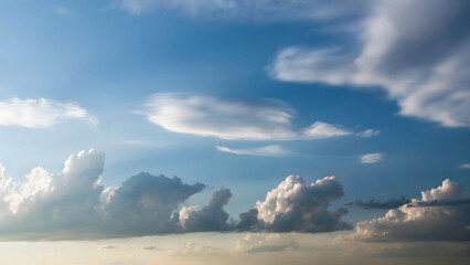 Dramatic cumulus clouds paint a vast blue sky with ethereal light inspiring wonder and vastness