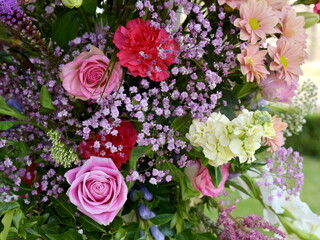 Bouquet of pink, red and white flowers. Roses and carnations.