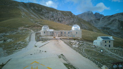 Aerial drone footage of the Astronomical Observatory of Abruzzo at Campo Imperatore, set against majestic mountain landscapes