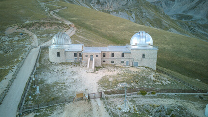 Aerial drone footage of the Astronomical Observatory of Abruzzo at Campo Imperatore, set against majestic mountain landscapes