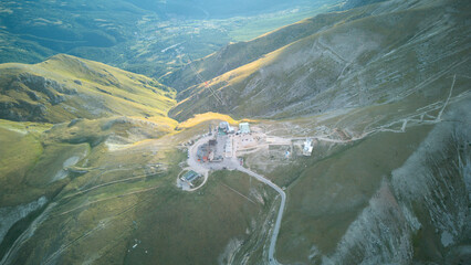 Aerial drone footage of the Astronomical Observatory of Abruzzo at Campo Imperatore, set against majestic mountain landscapes