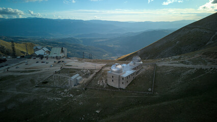 Aerial drone footage of the Astronomical Observatory of Abruzzo at Campo Imperatore, set against majestic mountain landscapes