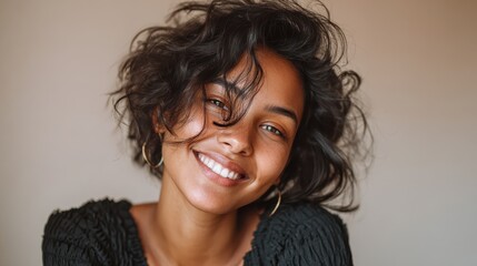 indoor portrait of beautiful brunette young darkskinned woman with shaggy hairstyle smiling cheerfully showing her white teeth to camera while feeling happy and carefree on her first dayoff no logos 