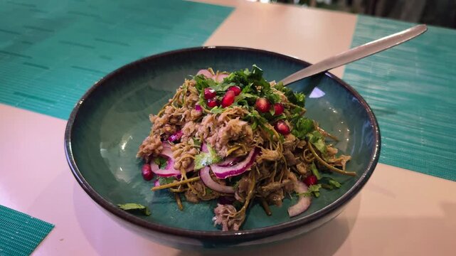  Traditional Georgian pickled dish Jonjoli. Pickled young shoots of caper bush with flowers, drizzled with vegetable oil, and sprinkled with chopped onions or green onions. High quality 4k footage