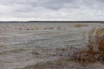 Lake in windy and cloudy weather. Autumn