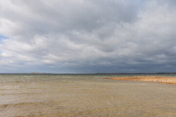 Lake in windy and cloudy weather. Autumn