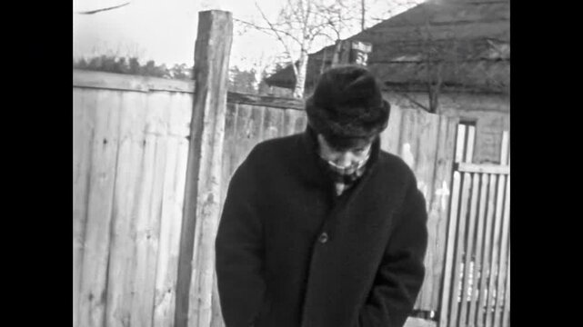 Man introverted in winter coat in abandoned outdoors. Depressed, cold, emotional closed, taciturn person. Vulnerability masculinity frustration feelings. Vintage film. Old archive. Archival retro