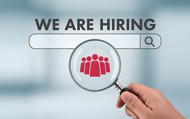 Recruitment and career opportunity concept with magnifying glass focusing on we are hiring search bar representing job offer, employment, and business growth