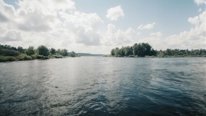 Serene River Landscape with Lush Green Banks and Cloudy Sky.