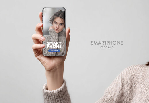 Woman holding smartphone. Mobile design mockup.