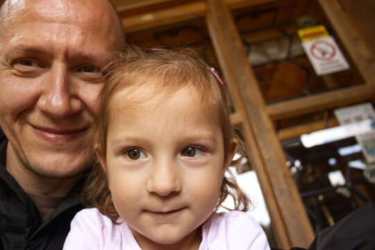 Selfie portrait of daughter and dad. Dad and daughter waiting to enter tourist attraction. Two year old daughter and father. Parents and children spending time together. - Powered by Adobe