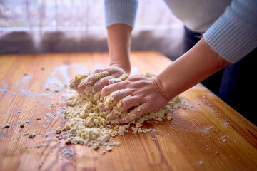 a mother and teenage daughter are cooking cookies together in the kitchen
