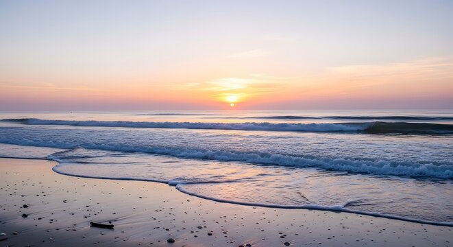 Serene ocean sunrise over sandy beach with gentle waves and pastel sky reflections