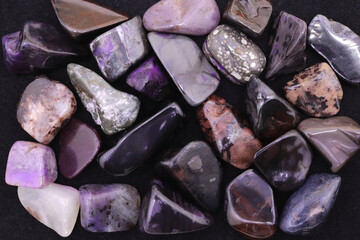 Sugilite heap jewel texture background. Pile mineral pebbles backdrop.Sugilite heap jewel stones texture background. Pile mineral pebbles backdrop.