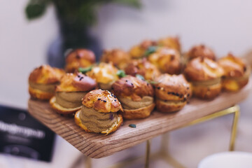 Beautifully decorated banquet catering table, with variety of with different food snacks appetizers on corporate birthday party event or wedding celebration, canape, salad, delicatessen setting