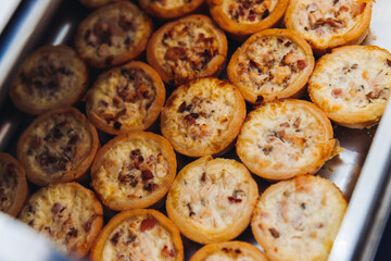 Beautifully decorated banquet catering table, with variety of with different food snacks appetizers on corporate birthday party event or wedding celebration, canape, salad, delicatessen setting