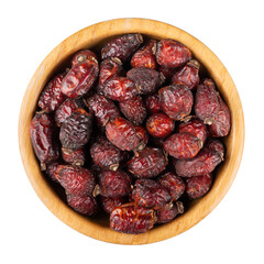 Dried rose hips, rosehips, dog-rose fruits in wooden bowl isolated on white background. Dried fruit. Top view.