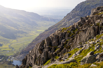 Fototapeta premium Panoramic Vista Down a Long Valley from a Rocky Cliff Edge