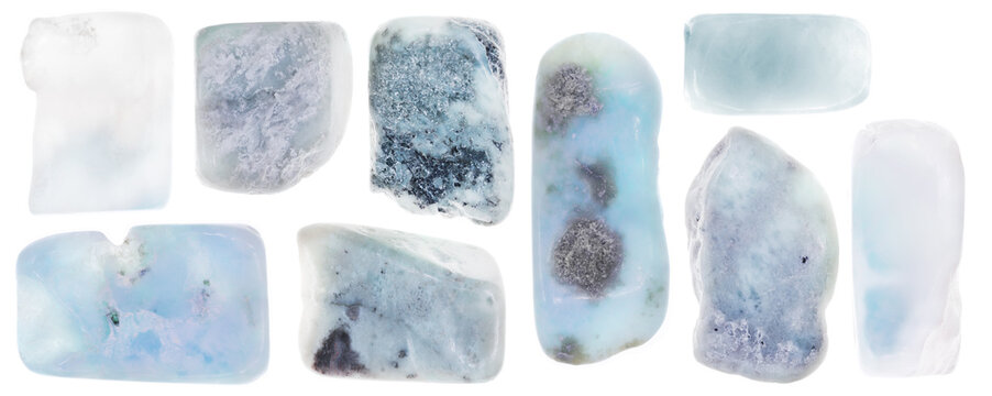 Larimar jewel stone texture in tweezers on light surface background. Macro closeup.