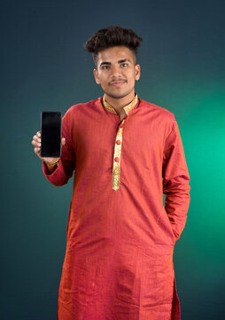 Young handsome traditional man showing a blank screen of a smartphone or mobile phone