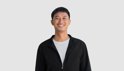 Young man in black coat smiling with happiness isolated on grey background