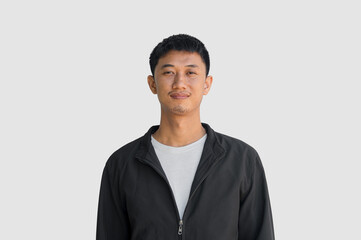 Young man in black coat smiling with happiness isolated on grey background