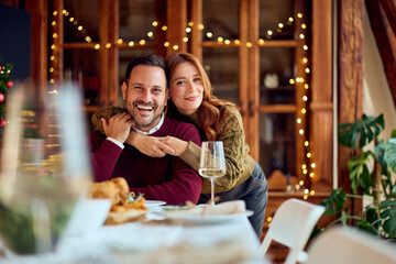 Joyful Couple At Festive New Year Dinner With Wine, Warm Lights, And Holiday Cheer