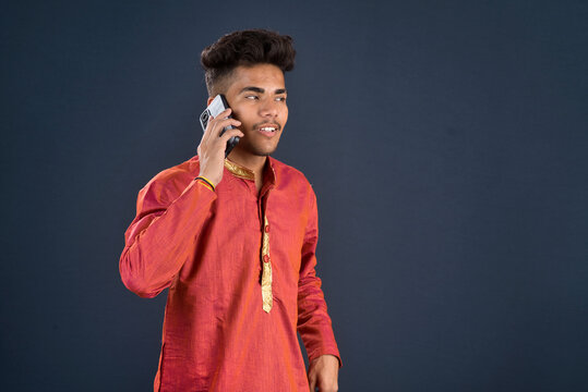 Young handsome man holding and using smartphone or mobile phone