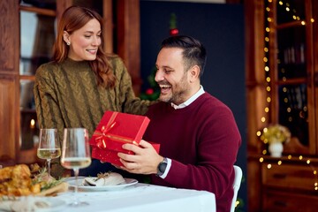 Couple Shares Joy With Gift Exchange At Festive New Year Dinner Celebration