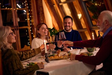 Friends And Family Toast At Cozy Dinner Party With Wine, Candles, And Warm Holiday Glow
