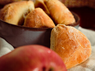 autumn seasonal baking, apple pie pastries, traditional ukrainian bakery, cozy atmosphere with apples, cinnamon sticks, white linen textile, warm tones knitwear