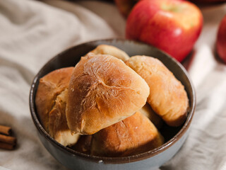 autumn seasonal baking, apple pie pastries, traditional ukrainian bakery, cozy atmosphere with apples, cinnamon sticks, white linen textile, warm tones knitwear