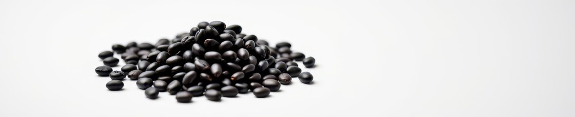 A mound of rich, dark organic black beans rests on a clean white surface, showcasing its natural texture and deep color, rich, white background, texture