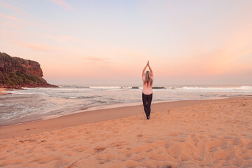 Woman wellness yoga exercise on beach