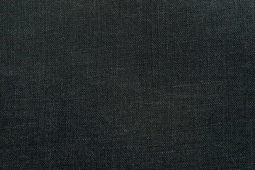 Close up view of black woven fabric. Quality linen textile texture ideal for backgrounds or design