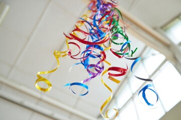 Colorful Streamers Cascading from Above, Creating a Festive Atmosphere in a Bright and Open Space