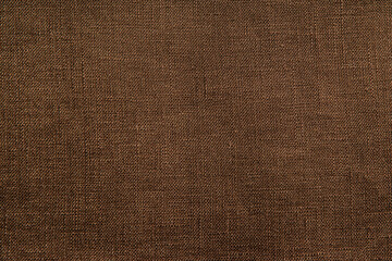 Close up view of chocolate brown woven fabric. Quality linen textile texture ideal for backgrounds or design