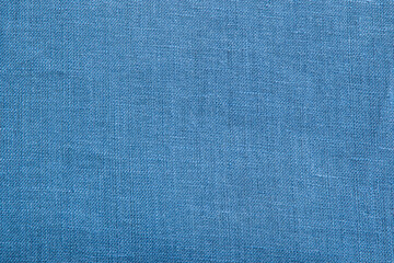 Close up view of denim blue woven fabric. Quality linen textile texture ideal for backgrounds or design