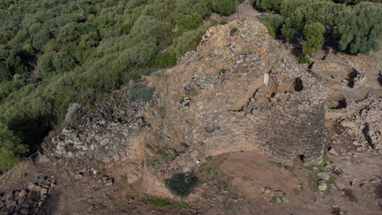 View of the Nuraghe Iloi archaeological site in Sedilo, Sardinia, featuring ancient basalt stone...