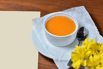 Pumpkin panna cotta on a table with food decor