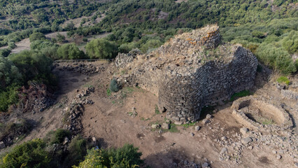 View of the Nuraghe Iloi archaeological site in Sedilo, Sardinia, featuring ancient basalt stone...