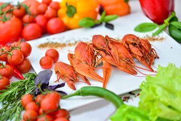 boiled crayfish large on a white plate on a table with food decor macro photo