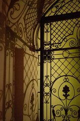 Beautiful fence casting shadow on a wall