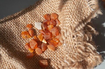 Baltic amber gemstones on rough hessian jute fabric background