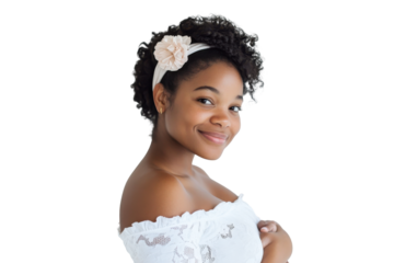Young black woman wearing a white off the shoulder top and headband isolated on transparent background. Pregnant woman smiling while cradling her baby bump isolated on white background.