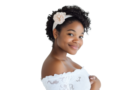 Young black woman wearing a white off the shoulder top and headband isolated on transparent background. Pregnant woman smiling while cradling her baby bump isolated on white background.