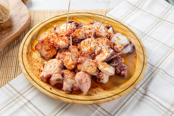 Pulpo a la gallega octopus tapas on a wooden plate