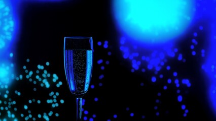 Close up of a champagne glass with golden bubbles against a backdrop of blue bokeh fireworks. A...