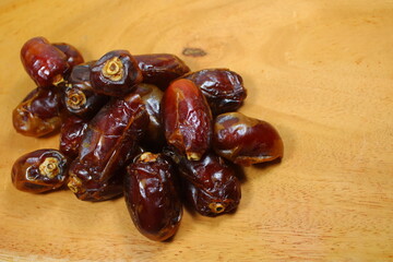 Sweet dried dates placed on a wooden board
