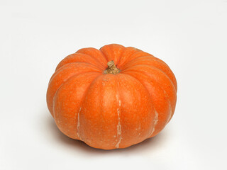A vibrant orange pumpkin isolated on a white background, perfect for fall-themed recipes and decor.